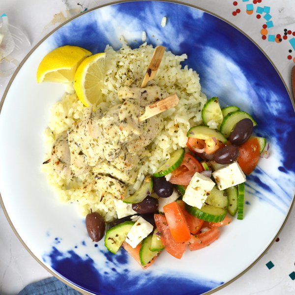 Chicken thighs souvlaki skewers, rice and greek salad
