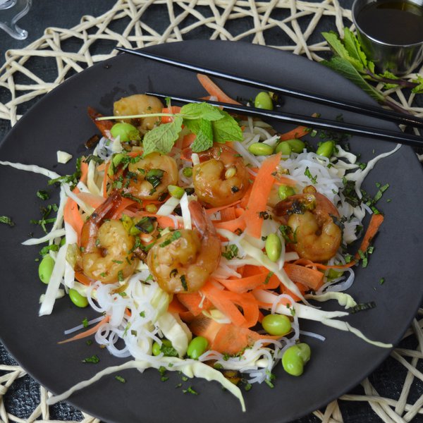 Bowl of honey glazed shrimp on a bed of salad