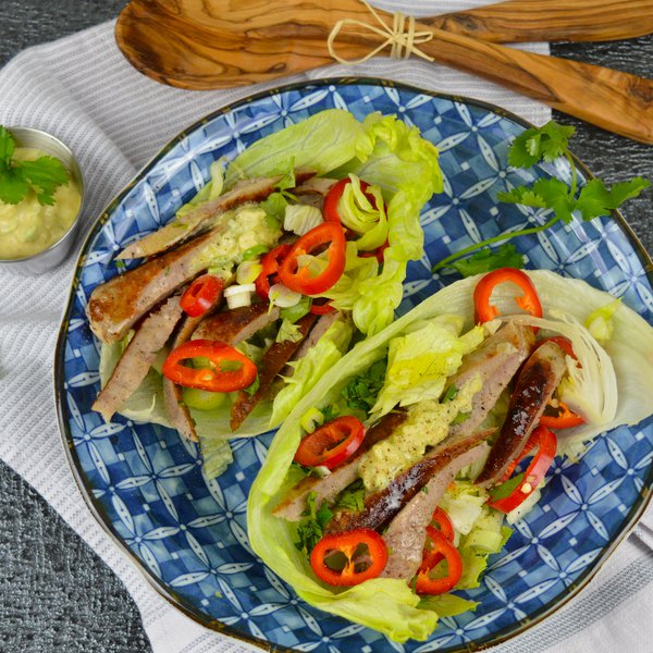 Lettuce wrap with cheddar-bacon sausages and avocado